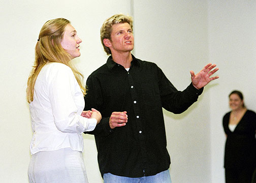 Rachel Payne (Trudy) looks on as Brent Schindele (Cain) sings See the Light